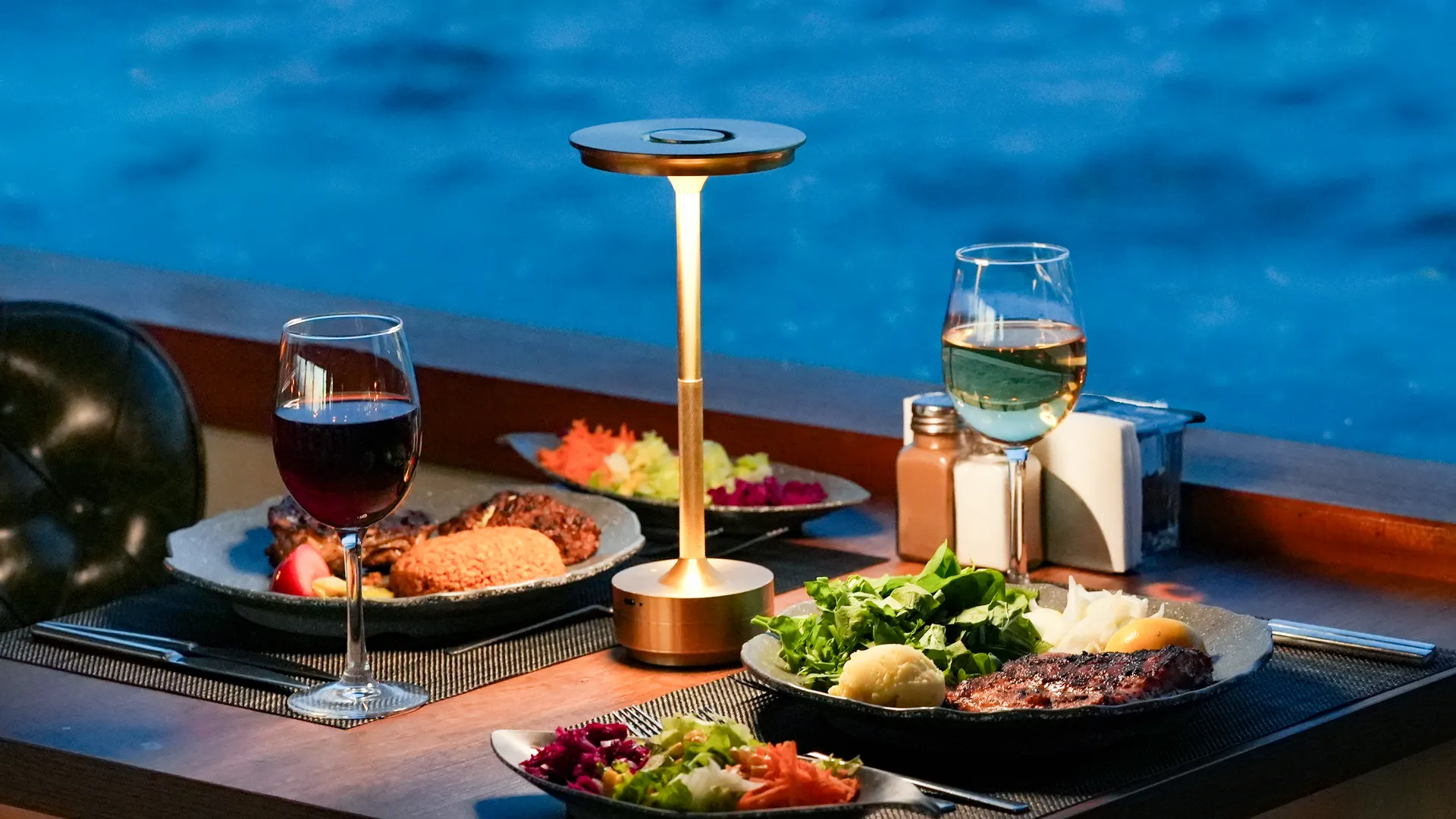 A grilled main course and red wine at a table overlooking the Bosphorus