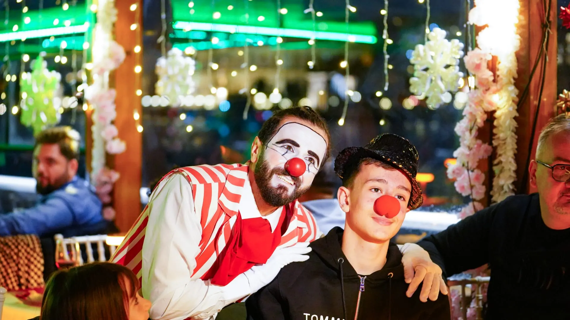 A clown performer entertaining a young guest on board