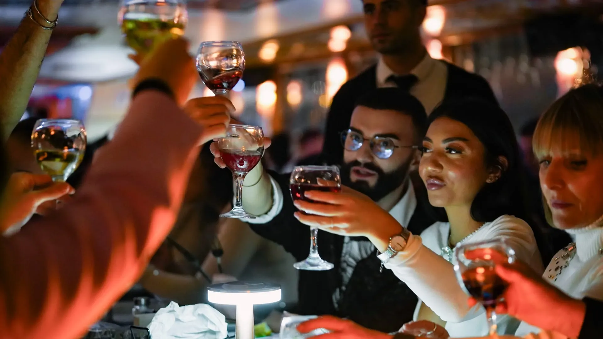 Smartly dressed guests raising a toast on the cruise